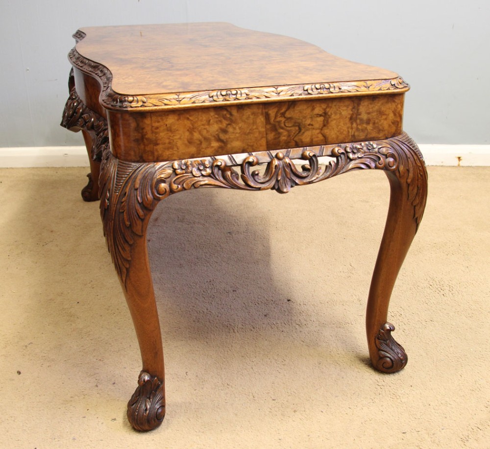 A low Queen Anne style burr walnut coffee table featuring carved cabriole legs, an ornate apron, and a serpentine book-matched top. View III