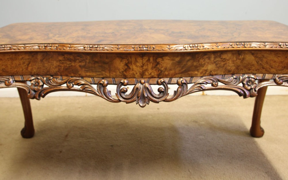 A low Queen Anne style burr walnut coffee table featuring carved cabriole legs, an ornate apron, and a serpentine book-matched top. View VI