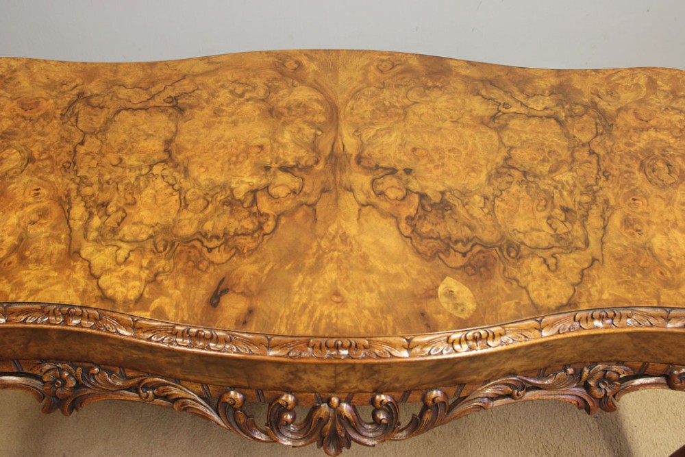 A low Queen Anne style burr walnut coffee table featuring carved cabriole legs, an ornate apron, and a serpentine book-matched top. View VII