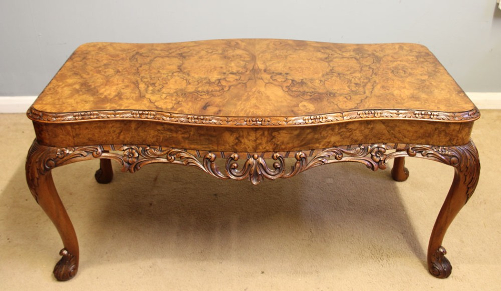 A low Queen Anne style burr walnut coffee table featuring carved cabriole legs, an ornate apron, and a serpentine book-matched top. View VIII