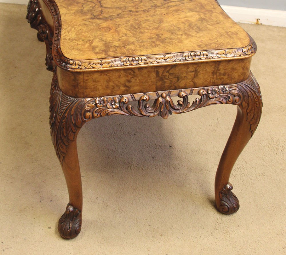A low Queen Anne style burr walnut coffee table featuring carved cabriole legs, an ornate apron, and a serpentine book-matched top. View IX