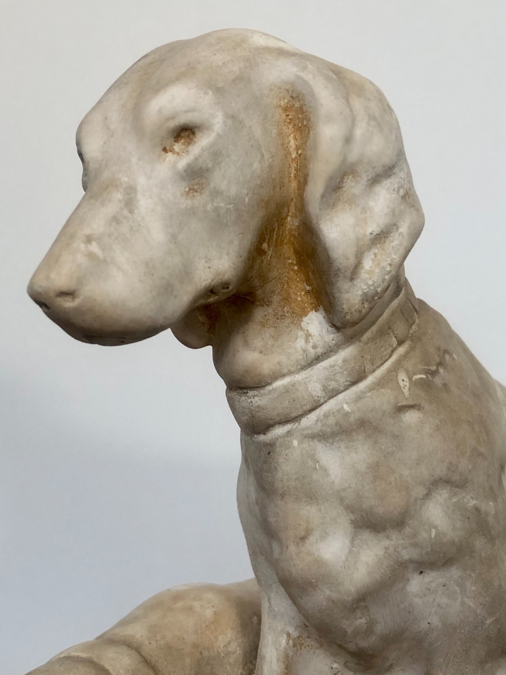 A 19th-century off-white Parian ware sculpture depicting two hunting hounds positioned on an integrated rectangular base. View VII