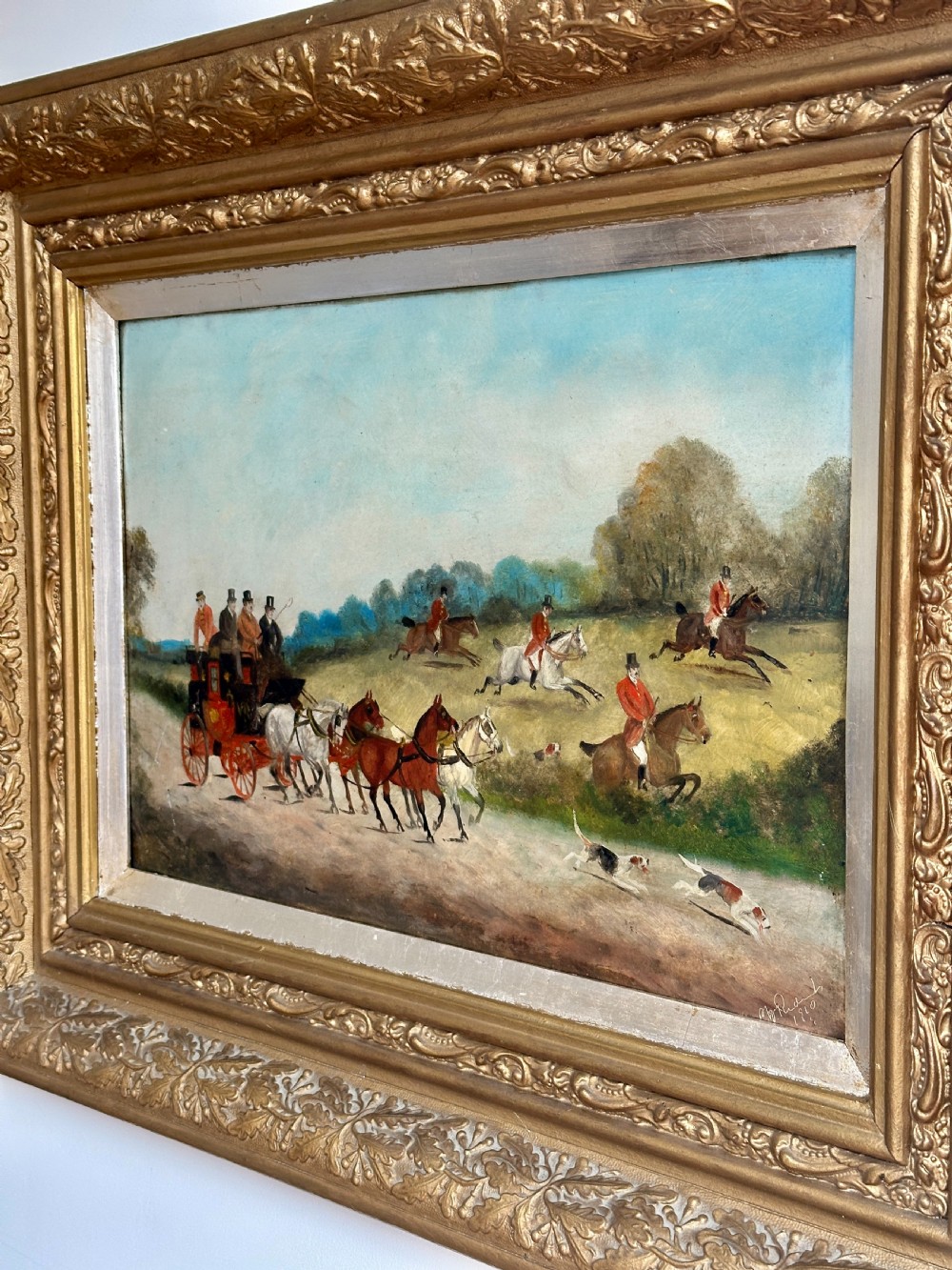 A pair of framed Edwardian oil paintings depicting horse-drawn coaches and fox hunting scenes within carved giltwood frames. View V