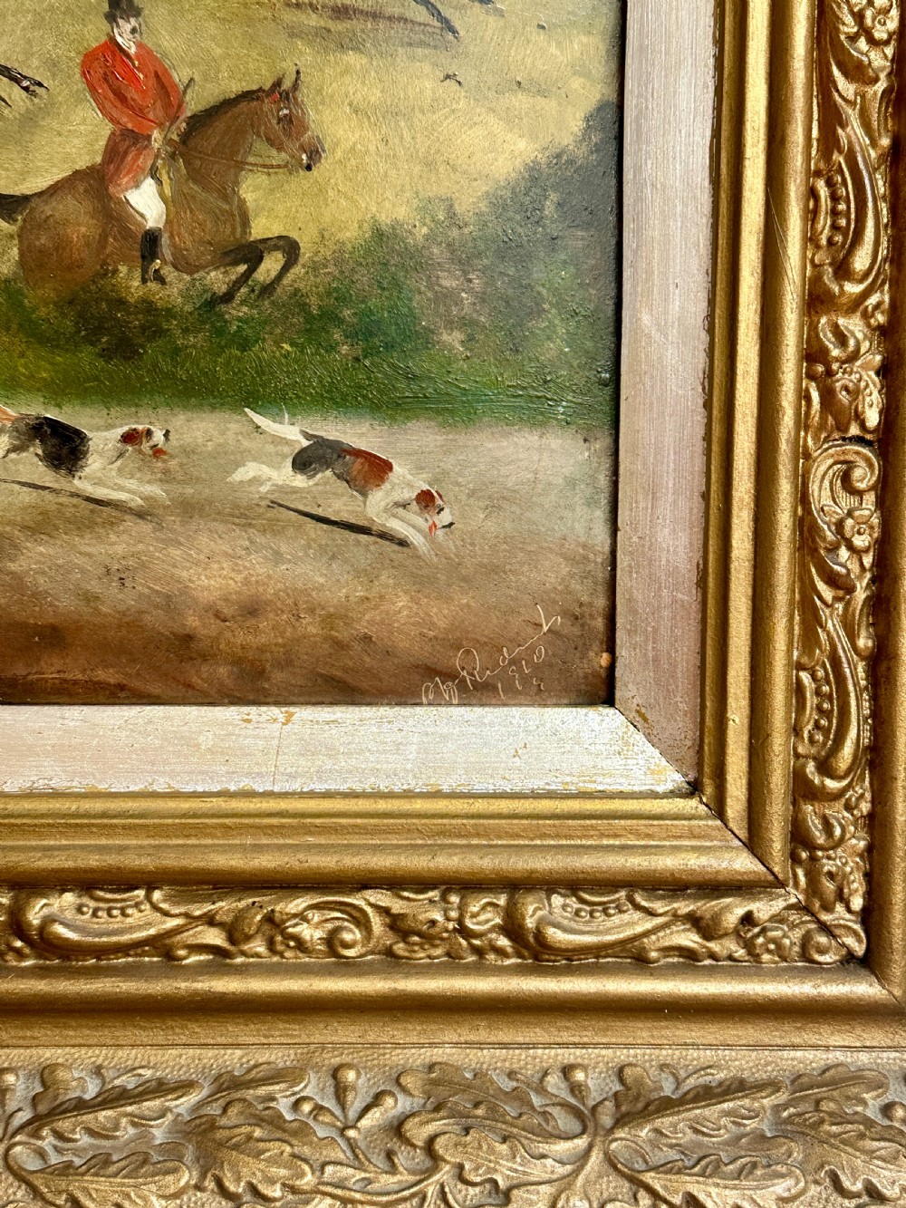 A pair of framed Edwardian oil paintings depicting horse-drawn coaches and fox hunting scenes within carved giltwood frames. View VI