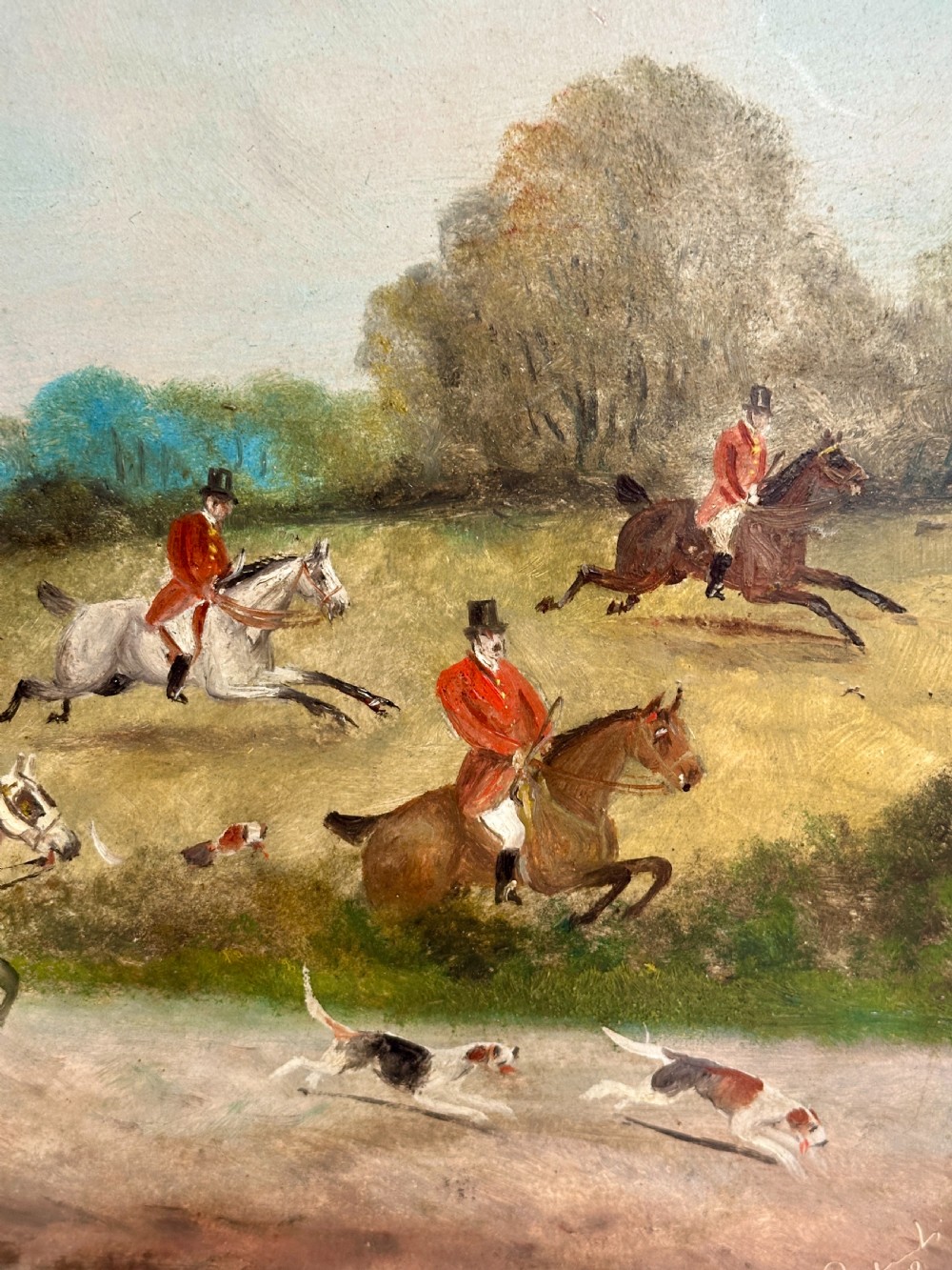 A pair of framed Edwardian oil paintings depicting horse-drawn coaches and fox hunting scenes within carved giltwood frames. View VII
