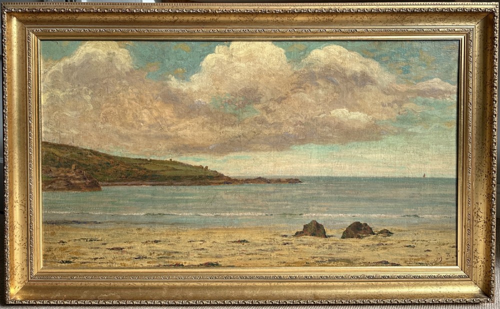 An early 20th-century framed oil painting depicting Porthmeor Beach with sandy shores and headland under a cloudy sky in a decorative gold frame.