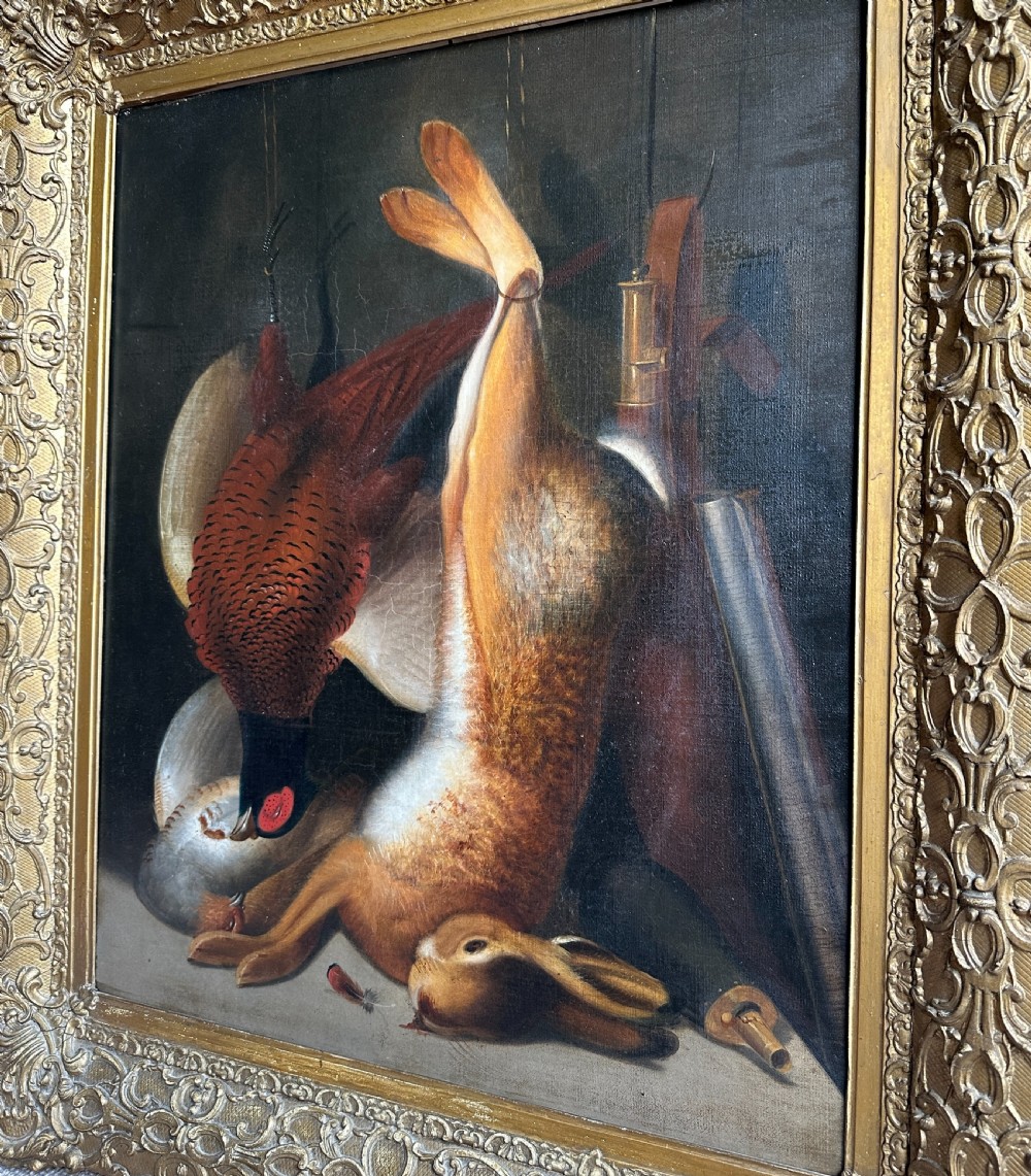 A 19th-century game still life oil painting depicting a hung hare and pheasant inside an ornate gold gilt frame. View IV