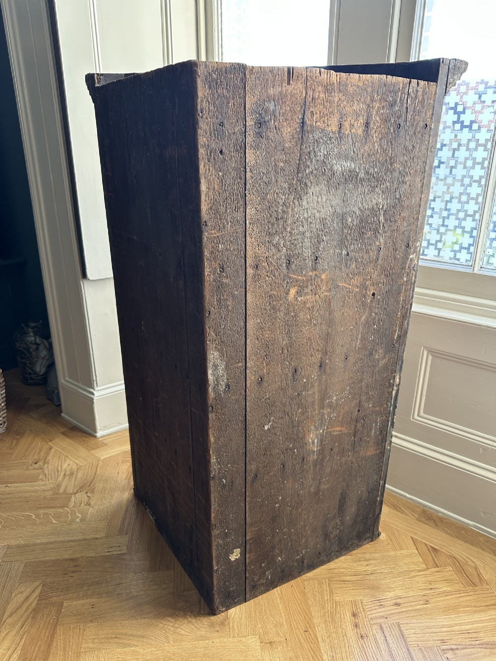 An antique stripped pine corner cabinet featuring a single glazed door with geometric astragal glazing bars and a dark painted interior. View VIII