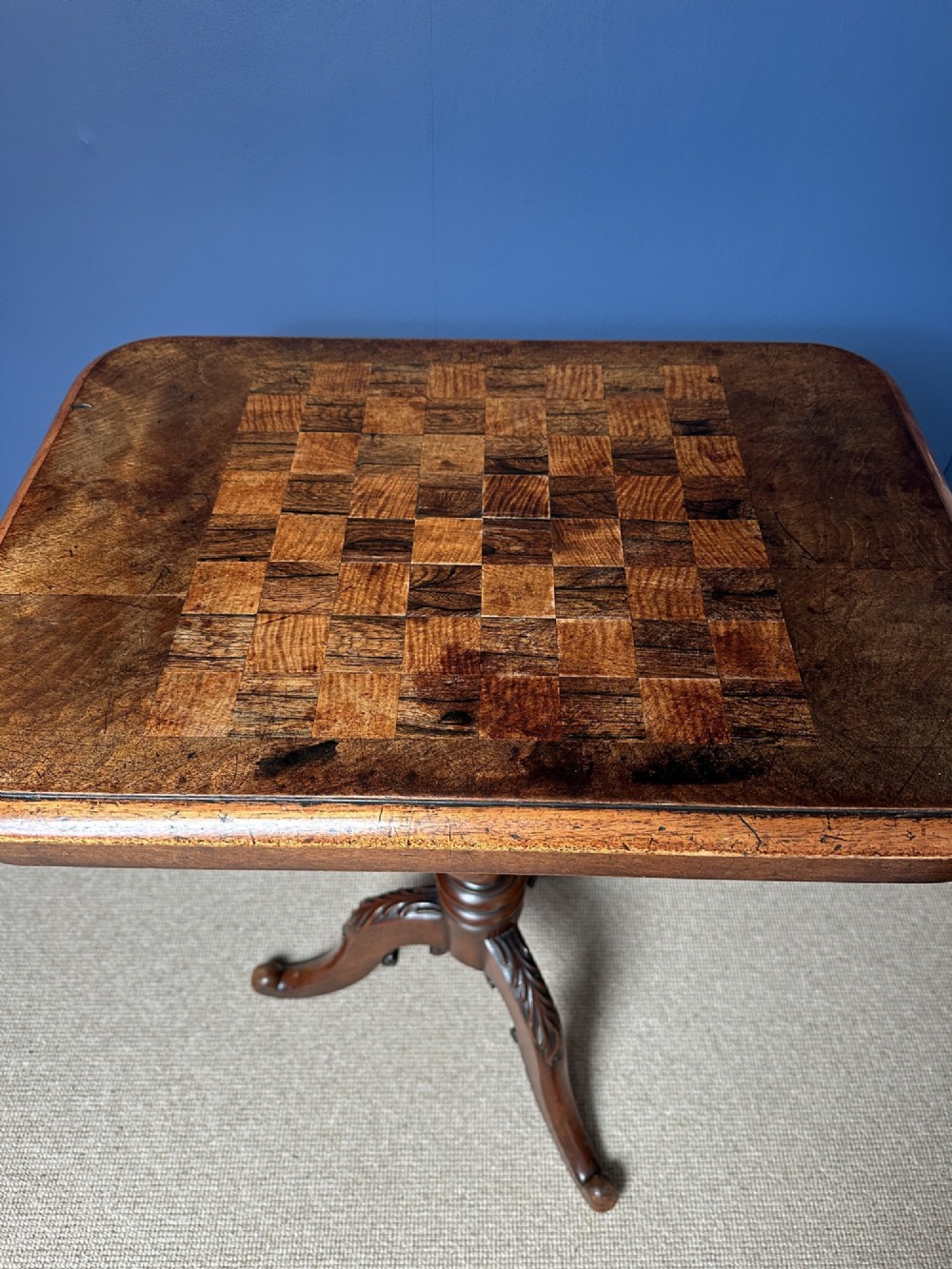 A Victorian walnut games table featuring a square top with an inlaid wooden chessboard surface, supported by a central barley twist column and carved tripod legs. View II