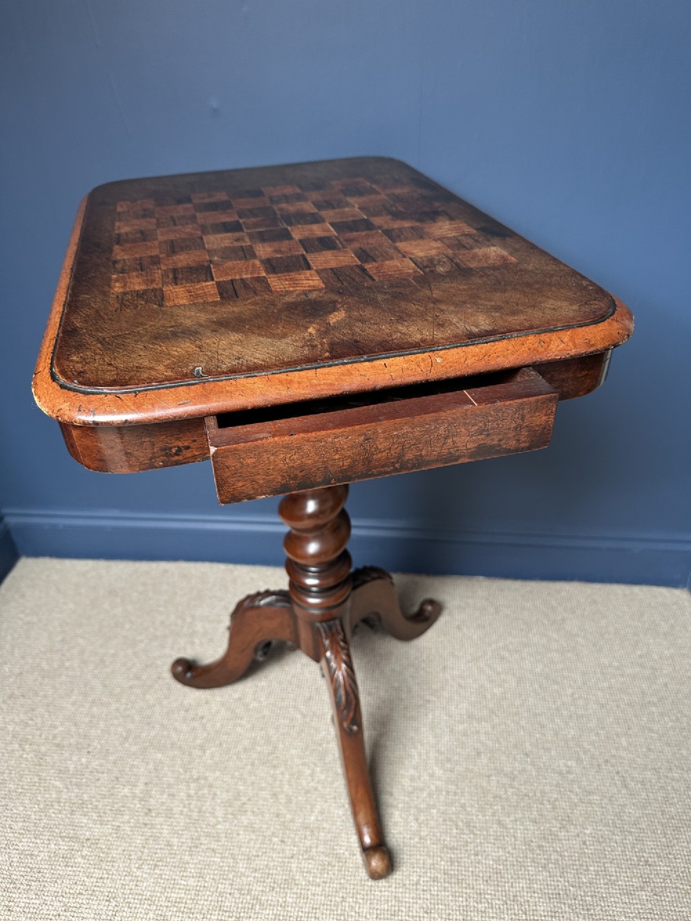 A Victorian walnut games table featuring a square top with an inlaid wooden chessboard surface, supported by a central barley twist column and carved tripod legs. View III