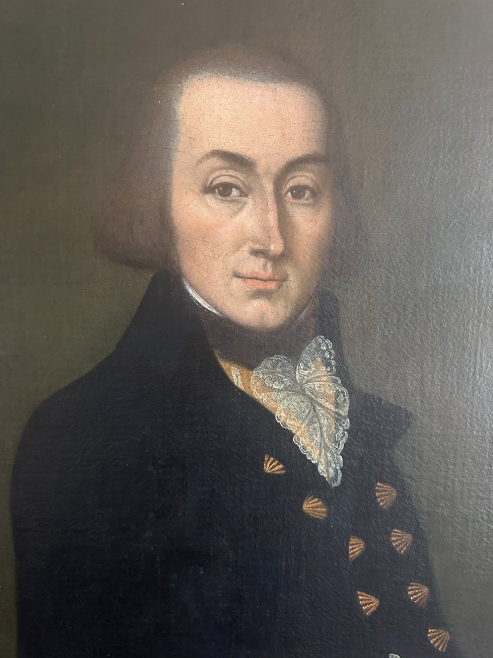 A late Georgian oil portrait of a gentleman in a dark coat with a white lace cravat set inside a giltwood frame. View IV