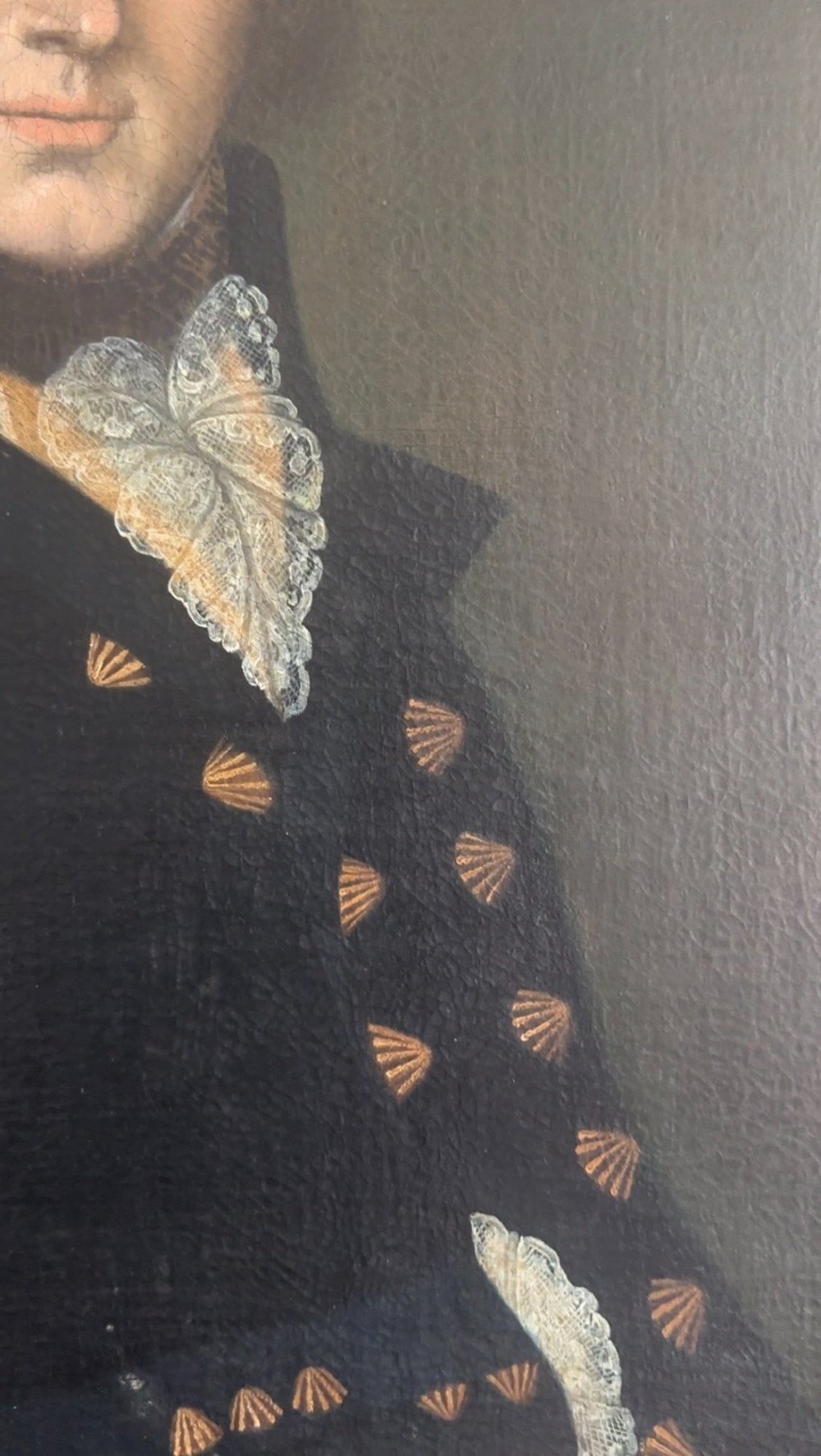 A late Georgian oil portrait of a gentleman in a dark coat with a white lace cravat set inside a giltwood frame. View V