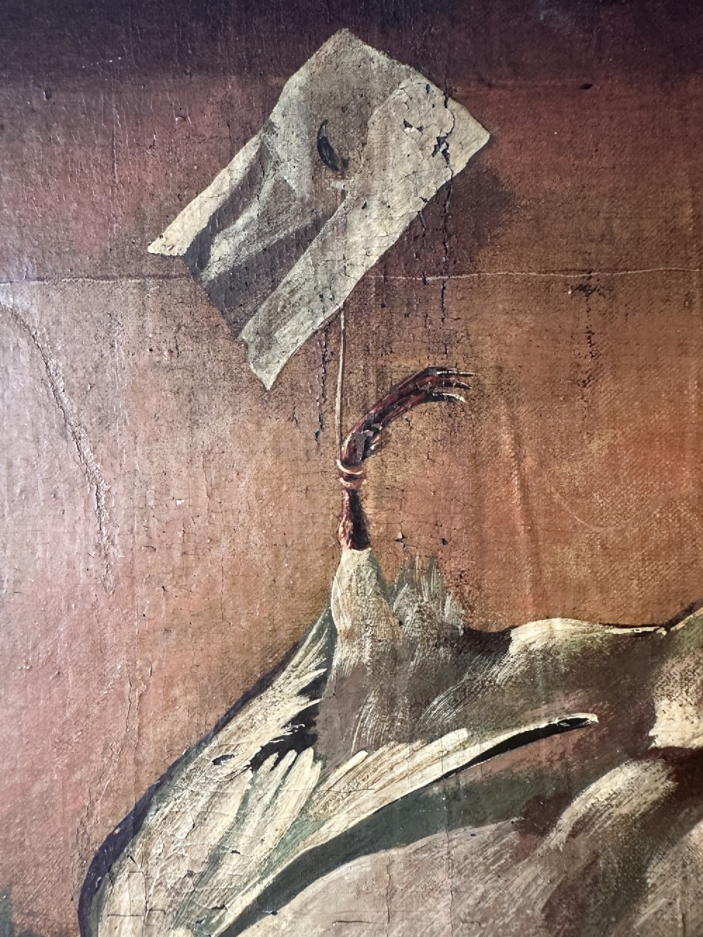 A 19th-century Continental school oil painting depicting hanging game birds and fruit arranged on a stone ledge within a gilded frame. View III