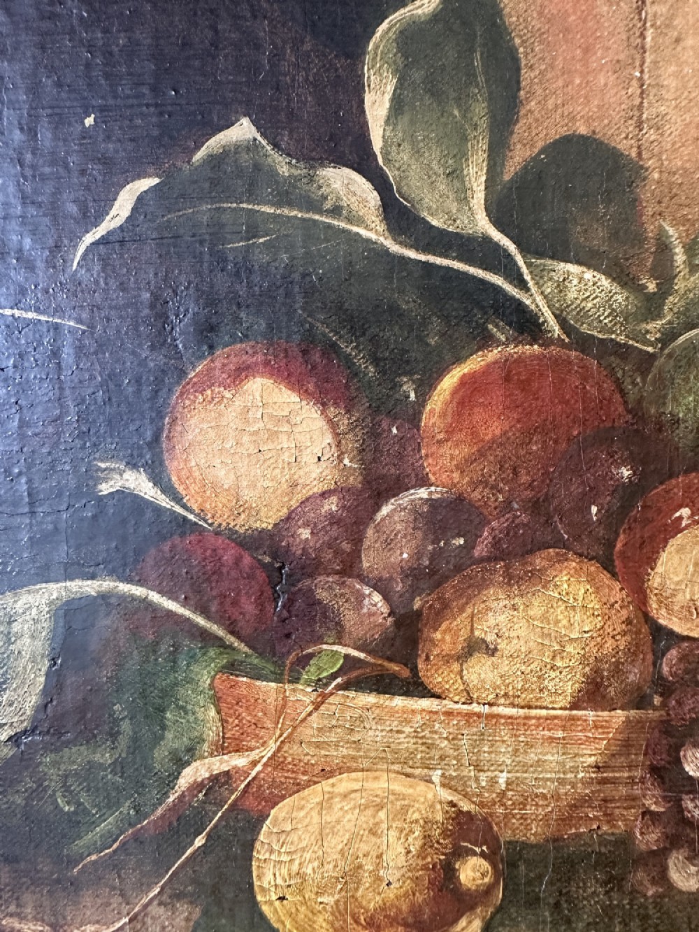 A 19th-century Continental school oil painting depicting hanging game birds and fruit arranged on a stone ledge within a gilded frame. View IV