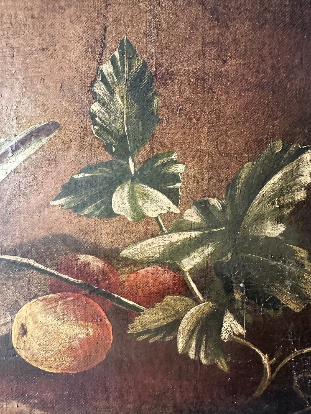 A 19th-century Continental school oil painting depicting hanging game birds and fruit arranged on a stone ledge within a gilded frame. View V