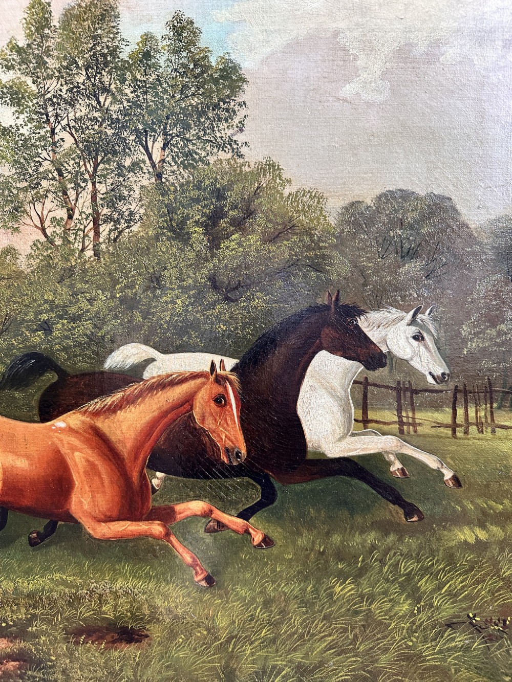 A 19th-century oil painting on canvas depicting three galloping horses in a landscape with a steam train in the background, framed in an ornate gilded wood frame. View IV