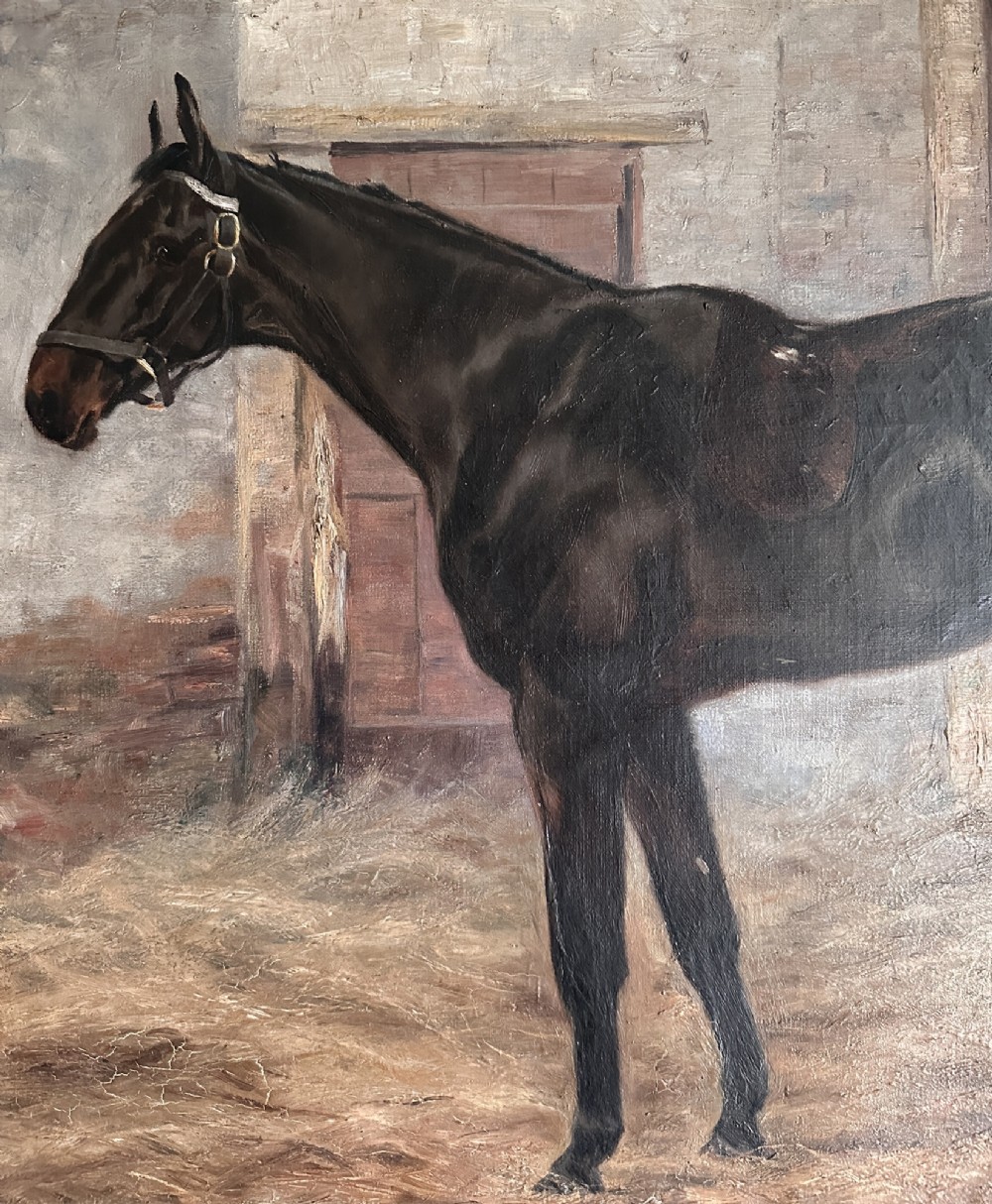 An 1896 oil painting depicting a dark brown horse standing inside a stable, housed within a gilded frame with a brass nameplate. View III