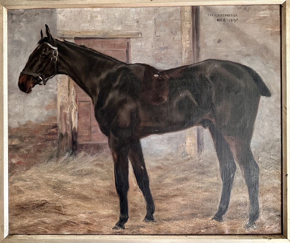 An 1896 oil painting depicting a dark brown horse standing inside a stable, housed within a gilded frame with a brass nameplate. View VII