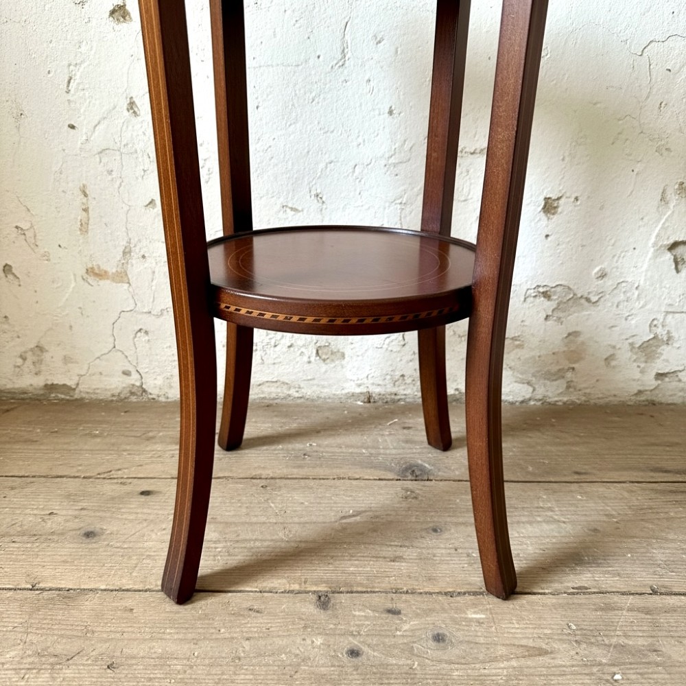 A tall, slender Edwardian mahogany plant stand featuring fine string inlay, splayed legs, and a lower circular shelf. View III