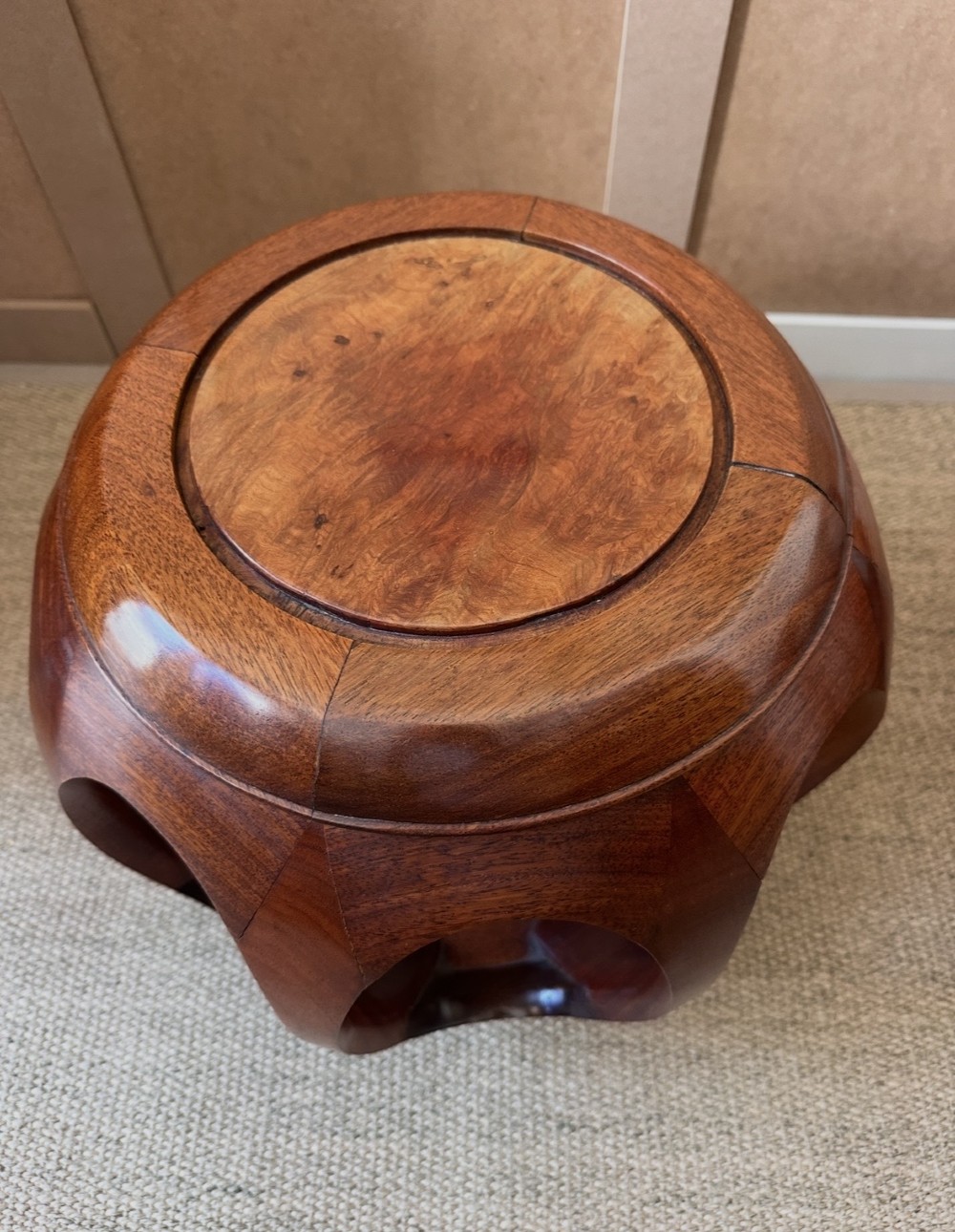 A pair of carved dark hardwood barrel stools featuring rounded openwork frames and circular burr wood inset tops. View IV