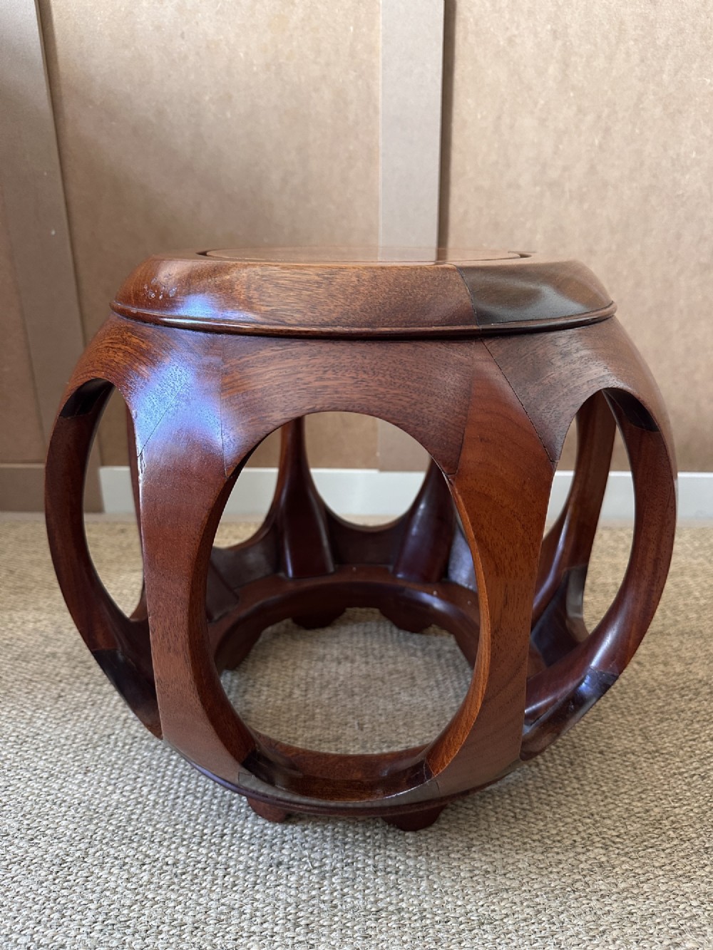 A pair of carved dark hardwood barrel stools featuring rounded openwork frames and circular burr wood inset tops. View VI