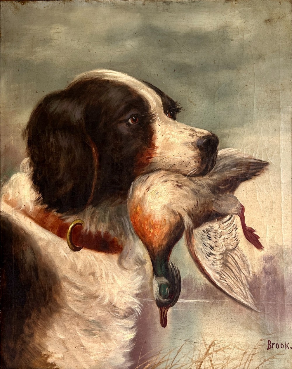 An early 20th-century oil painting depicting a brown and white gundog holding a mallard drake in its mouth, presented within an ornate gilt frame. View II
