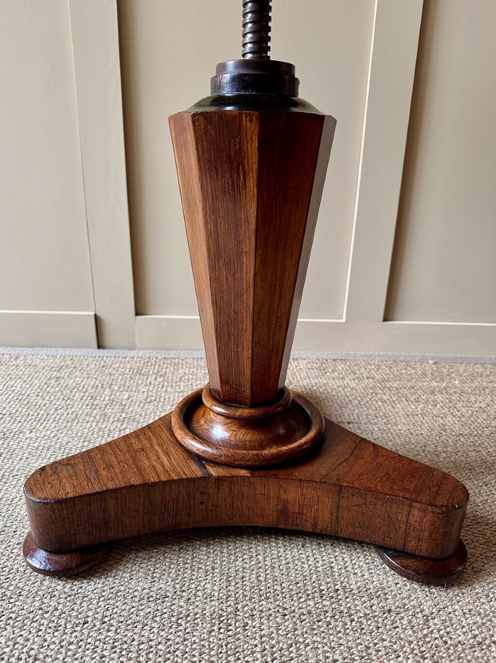 A William IV mahogany adjustable piano stool with a circular green velvet upholstered seat, supported by a faceted tapered column on a triform base. View II