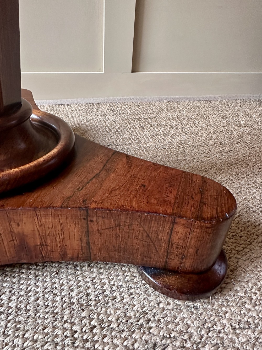 A William IV mahogany adjustable piano stool with a circular green velvet upholstered seat, supported by a faceted tapered column on a triform base. View IV