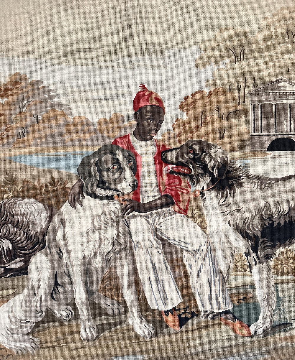 A framed Victorian Berlin woolwork tapestry depicting a seated figure with two dogs in a parkland setting within a moulded gilt frame. View III