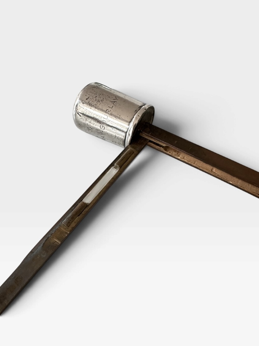 An antique malacca wood walking cane featuring a polished silver collar and cap. View V