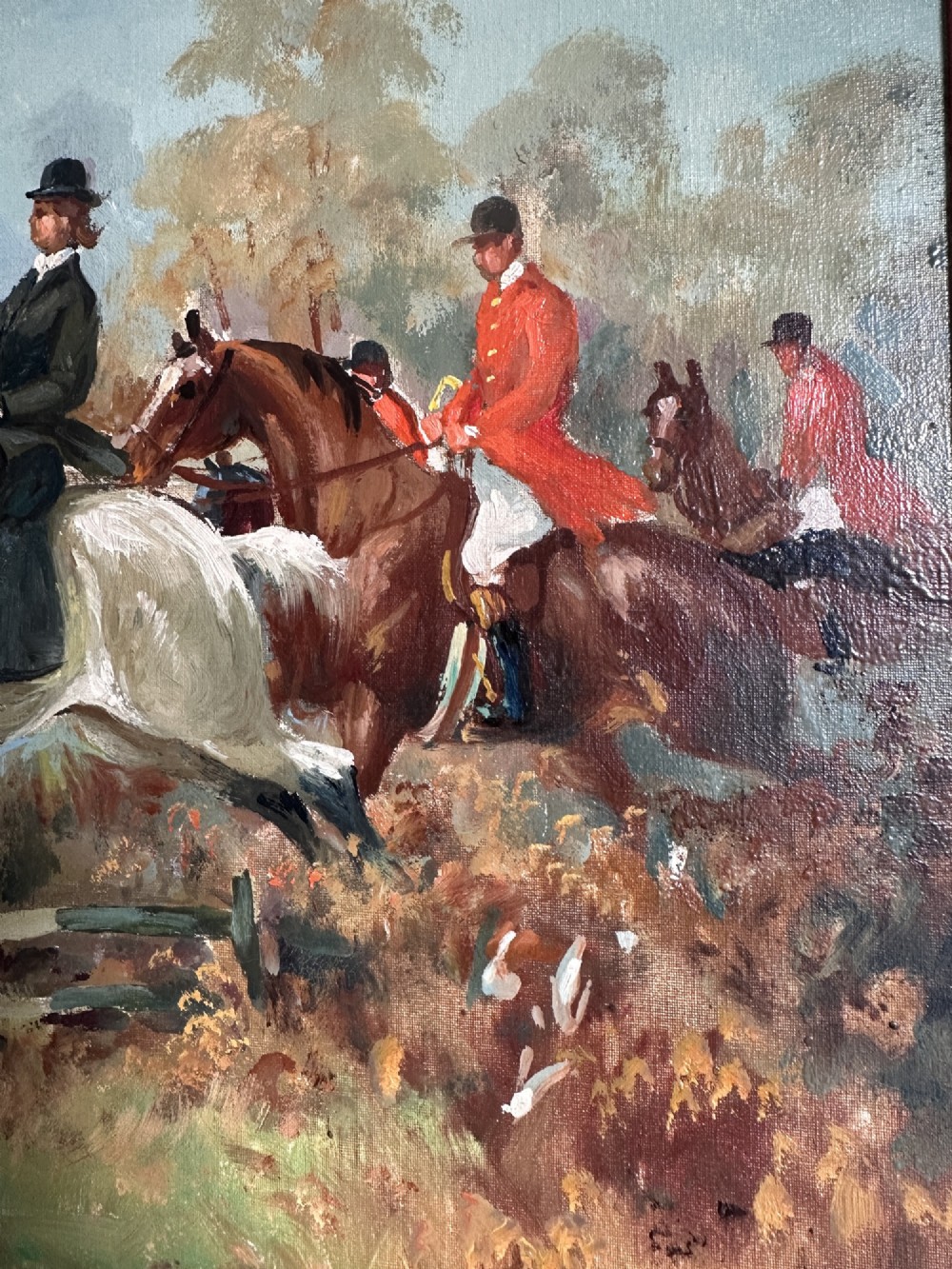 An oil painting depicting a fox hunting scene with horse riders and foxhounds across a green countryside landscape, presented in a gold gilded wooden frame. View V
