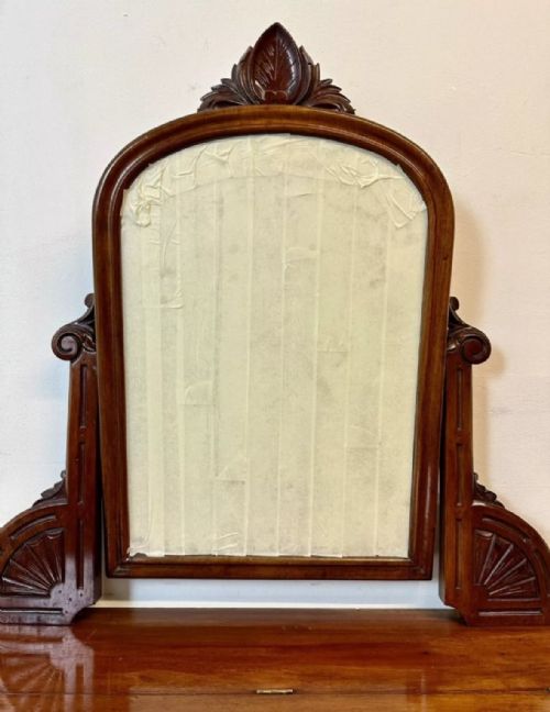fig 2. A late 19th-century Victorian mahogany Duchess dressing table with an arched mirror frame, carved cresting, turned central leg, and shaped plinth base.