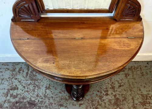 fig 3. A late 19th-century Victorian mahogany Duchess dressing table with an arched mirror frame, carved cresting, turned central leg, and shaped plinth base.