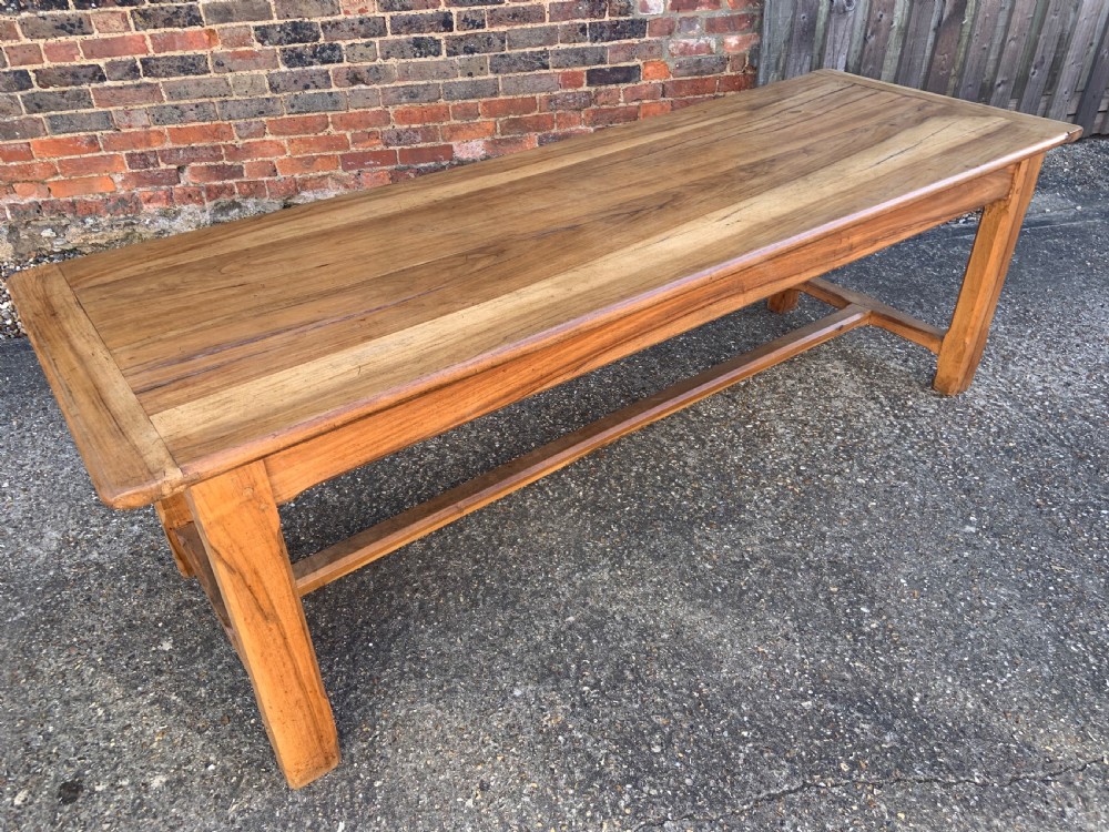 A late nineteenth-century pale walnut refectory dining table featuring a rectangular plank top with breadboard ends supported by legs joined by an H-stretcher. View IV