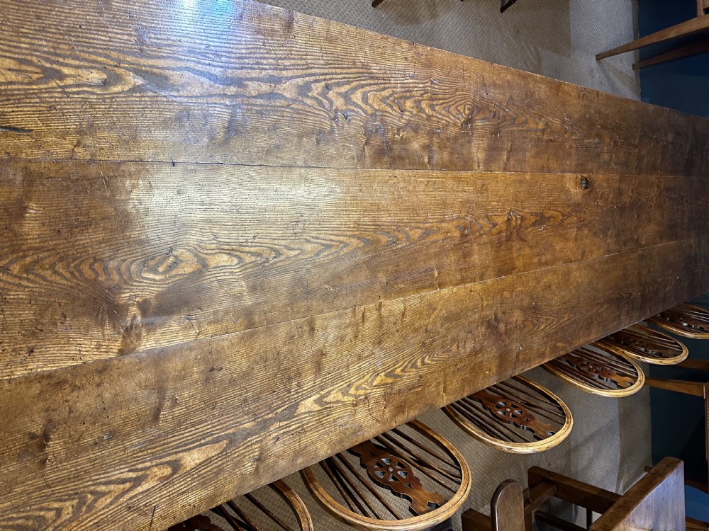 A large rectangular wooden dining table featuring a weathered grain top and tapered legs. View IV