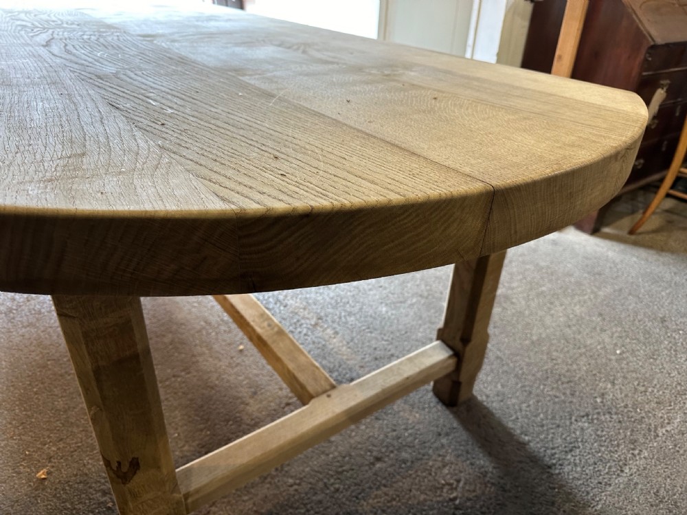 An overhead view of a long, bleached oak refectory table with rounded oval ends and sturdy stretcher-base legs. View IV