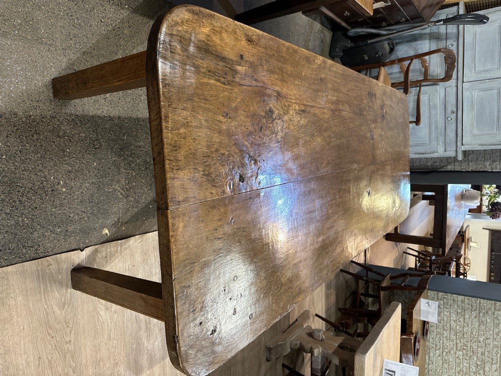 An early 19th-century rectangular dining table made from beech wood featuring a two-plank top with rounded corners and four tapered square legs. View IV
