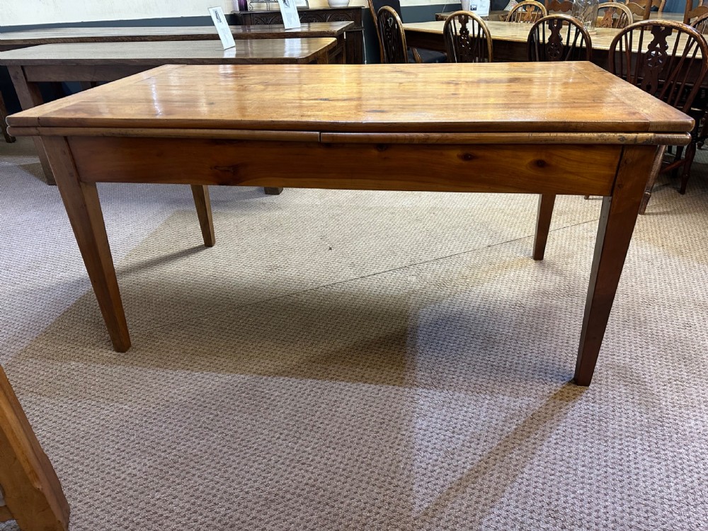 A 19th-century French provincial cherrywood dining table featuring a double draw-leaf mechanism and four square tapered legs. View II