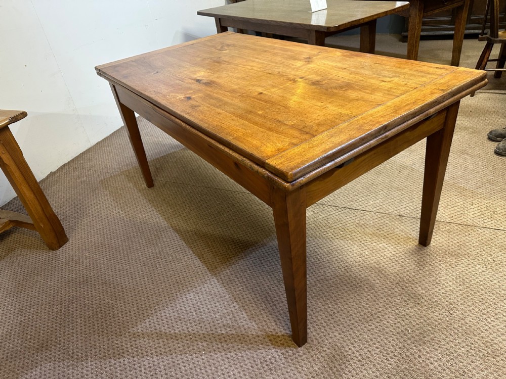 A 19th-century French provincial cherrywood dining table featuring a double draw-leaf mechanism and four square tapered legs. View III