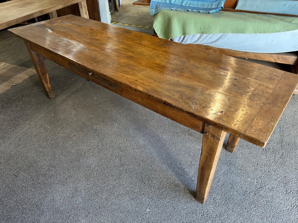 A nineteenth-century rectangular beech farmhouse dining table featuring a patinated wood top, a single side drawer with a small pull handle, and tapered wooden legs. View III