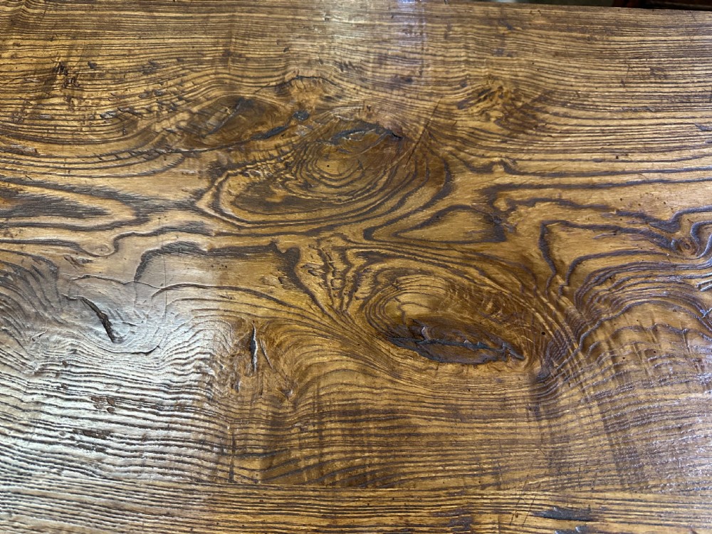 A rectangular antique solid ash dining table featuring a prominent wood grain top and sturdy square legs joined by low end stretchers. View II