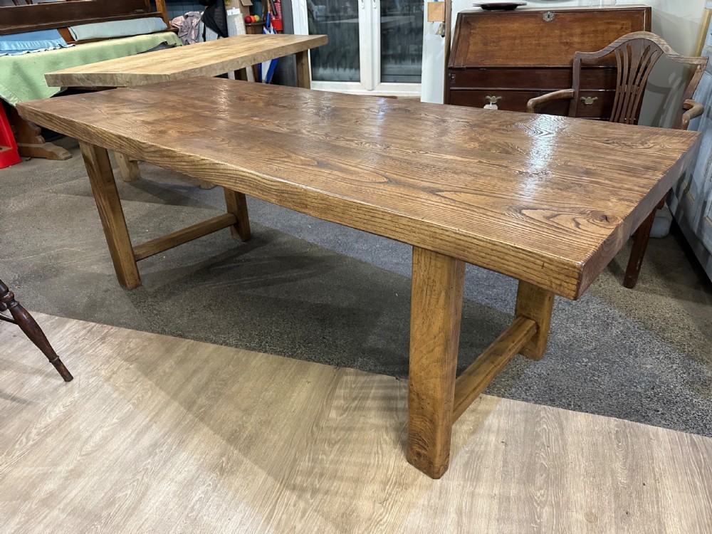 A rectangular antique solid ash dining table featuring a prominent wood grain top and sturdy square legs joined by low end stretchers. View IV