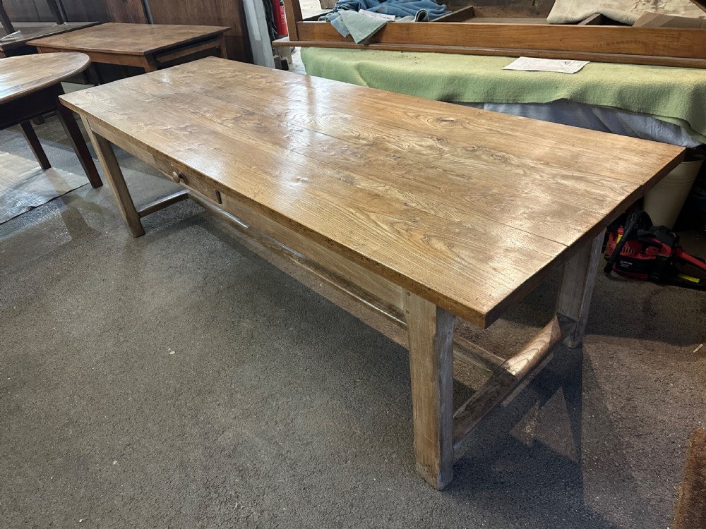 A nineteenth-century rectangular elm farmhouse table featuring a side frieze drawer, square legs, and a low stretcher rail. View III