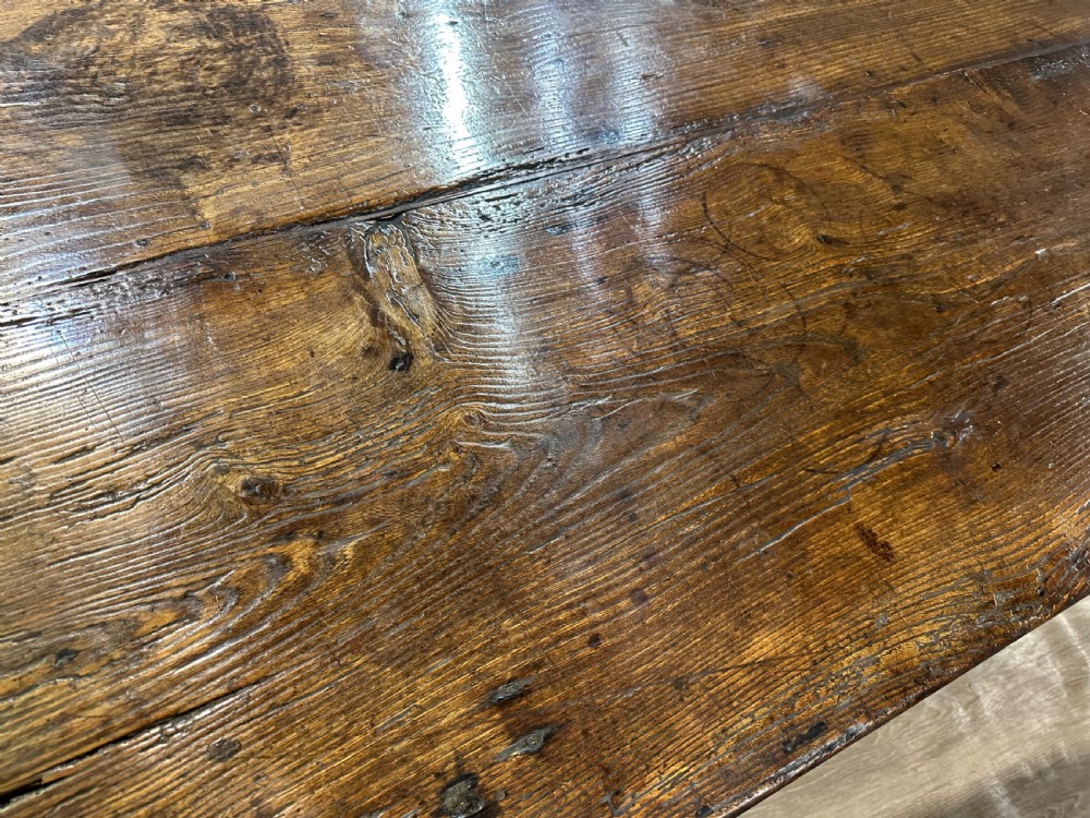 A long 18th-century dark wood farmhouse dining table featuring a plank top and square legs with end stretchers. View VIII