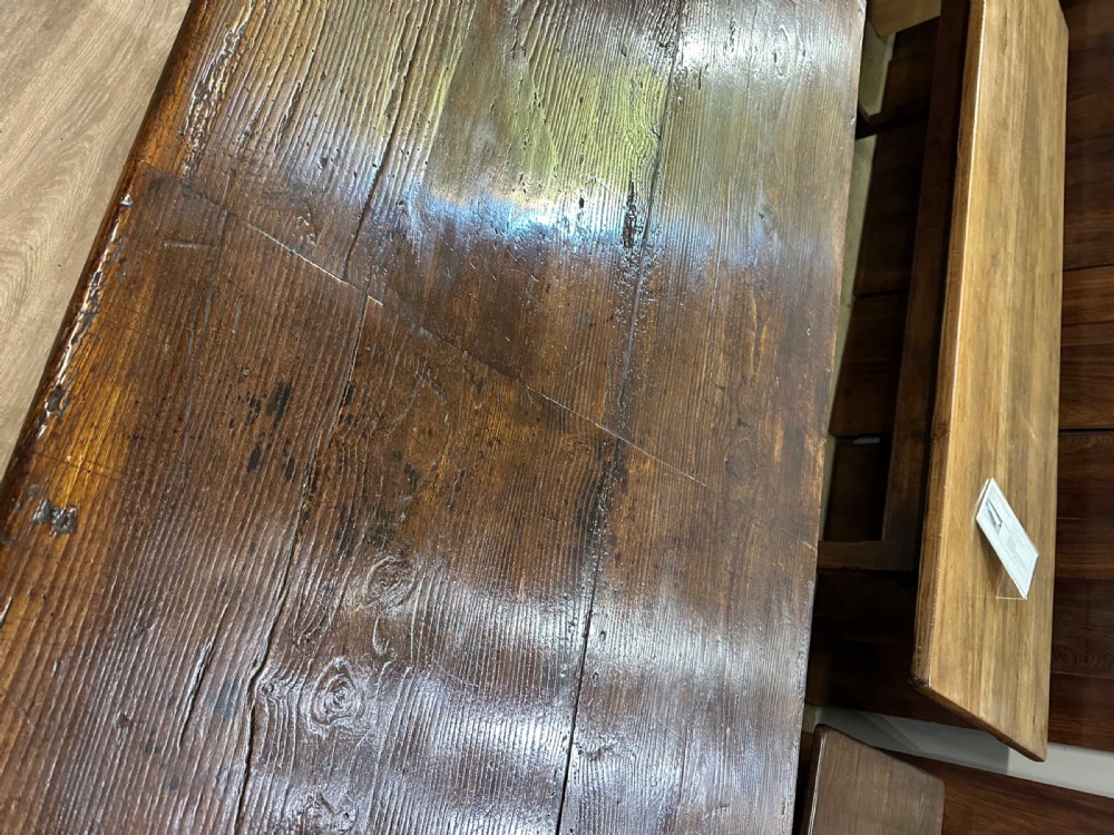 A long 18th-century dark wood farmhouse dining table featuring a plank top and square legs with end stretchers. View IX
