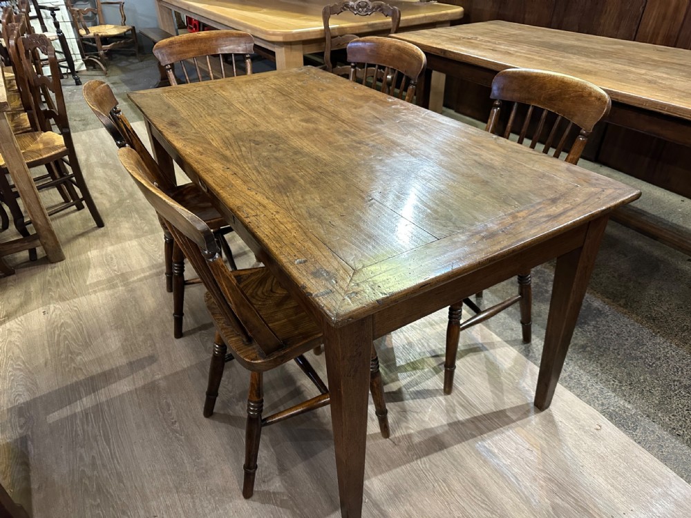 A 19th-century rectangular chestnut farmhouse table featuring a framed timber top, a single central frieze drawer, and four tapered square legs. View II