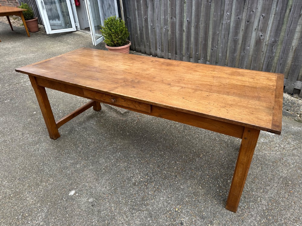 A 19th-century rectangular ash wood farmhouse dining table featuring a frieze drawer and end stretchers. View II