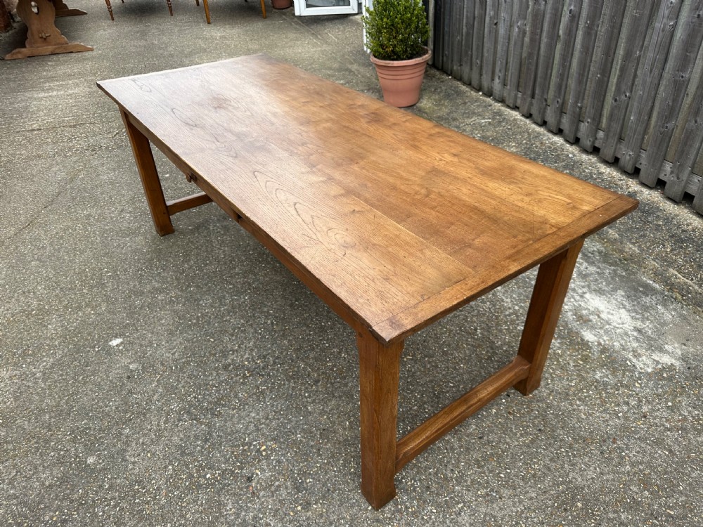 A 19th-century rectangular ash wood farmhouse dining table featuring a frieze drawer and end stretchers. View III