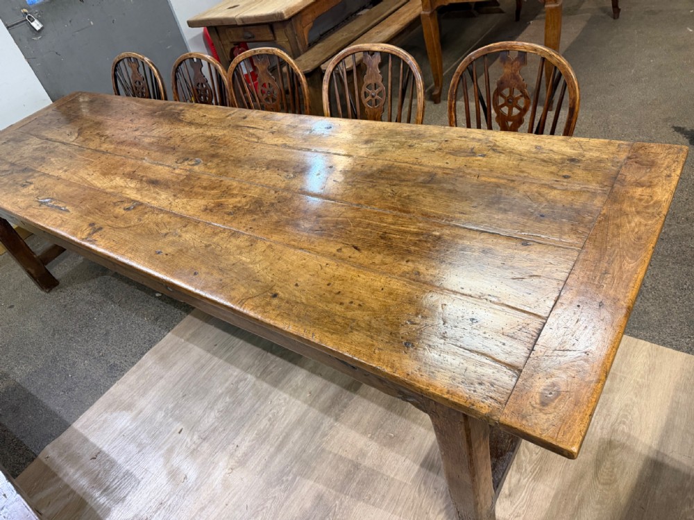 A long late 18th-century oak and beech farmhouse dining table featuring a plank top and squared legs joined by stretchers. View II