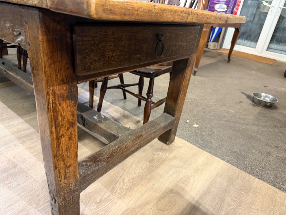 A long late 18th-century oak and beech farmhouse dining table featuring a plank top and squared legs joined by stretchers. View IV